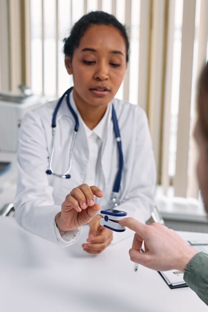 Hello world! Female doctor using pulse oximeter on patient's finger during a healthcare consultation.